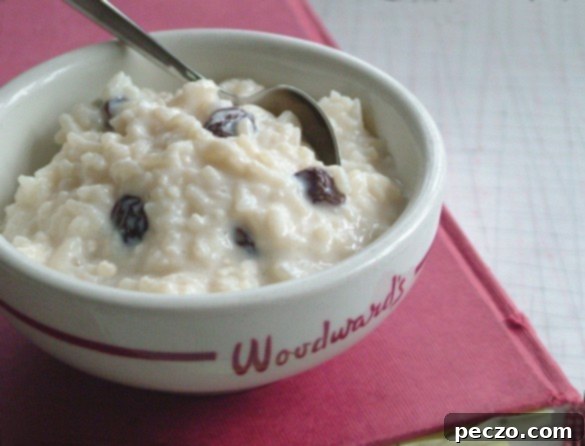 Creamy Rice Pudding served in a bowl, garnished with a sprinkle of cinnamon and a fresh mint leaf.