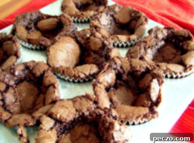 Baked sunken chocolate cupcakes, still in tins