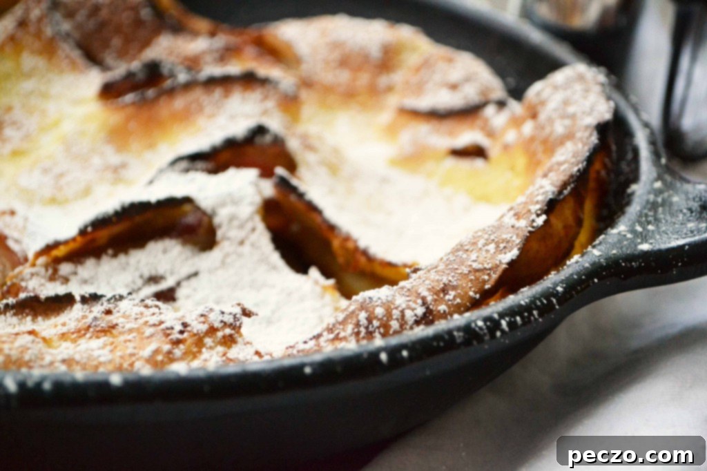 Puffed Apple Pancake served in wedges with fruit