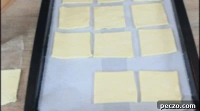 Puff pastry squares on baking sheet