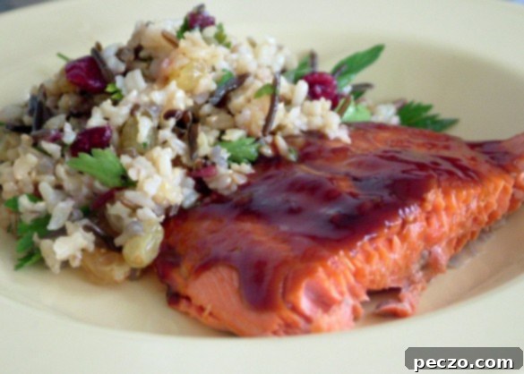 Hoisin Salmon paired with a fresh summer salad and a glass of sangria, perfect for a summer meal.