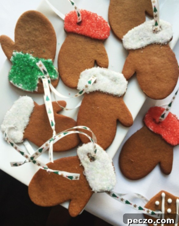 Elizabeth Baird and fellow bakers meticulously decorating gingerbread cookies shaped like mittens with royal icing