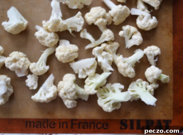 Fresh cauliflower florets ready for preparation, a key ingredient for delicious fritters.