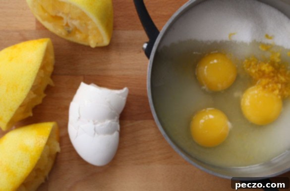 Key ingredients for homemade lemon curd: fresh lemons, eggs, sugar, and butter.