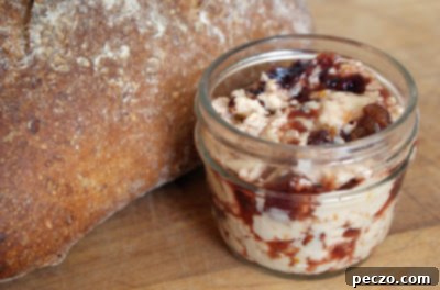 A small jar of homemade cherry bourbon butter, rich and inviting.