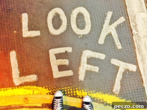 Look left - A typical London street scene with a painted reminder on the pavement to 'look left' for oncoming traffic, highlighting the unique driving culture.