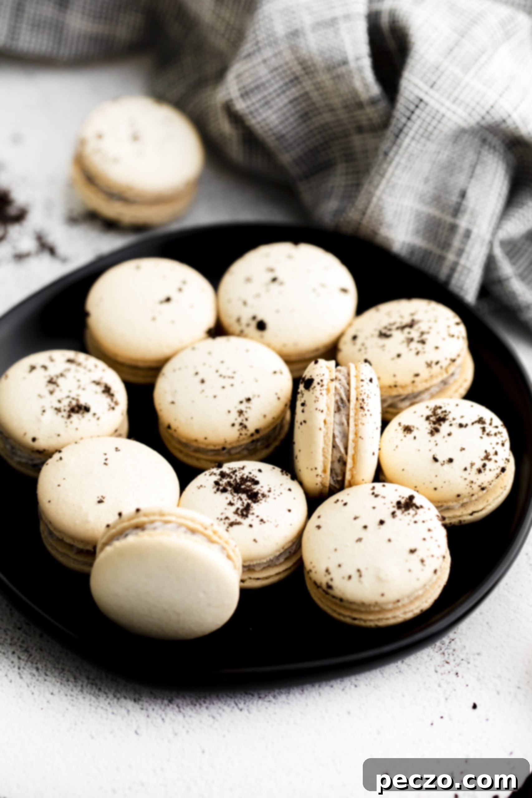 Delicious cookies and cream macarons beautifully arranged on a tray, highlighting their delicate shells and creamy filling.