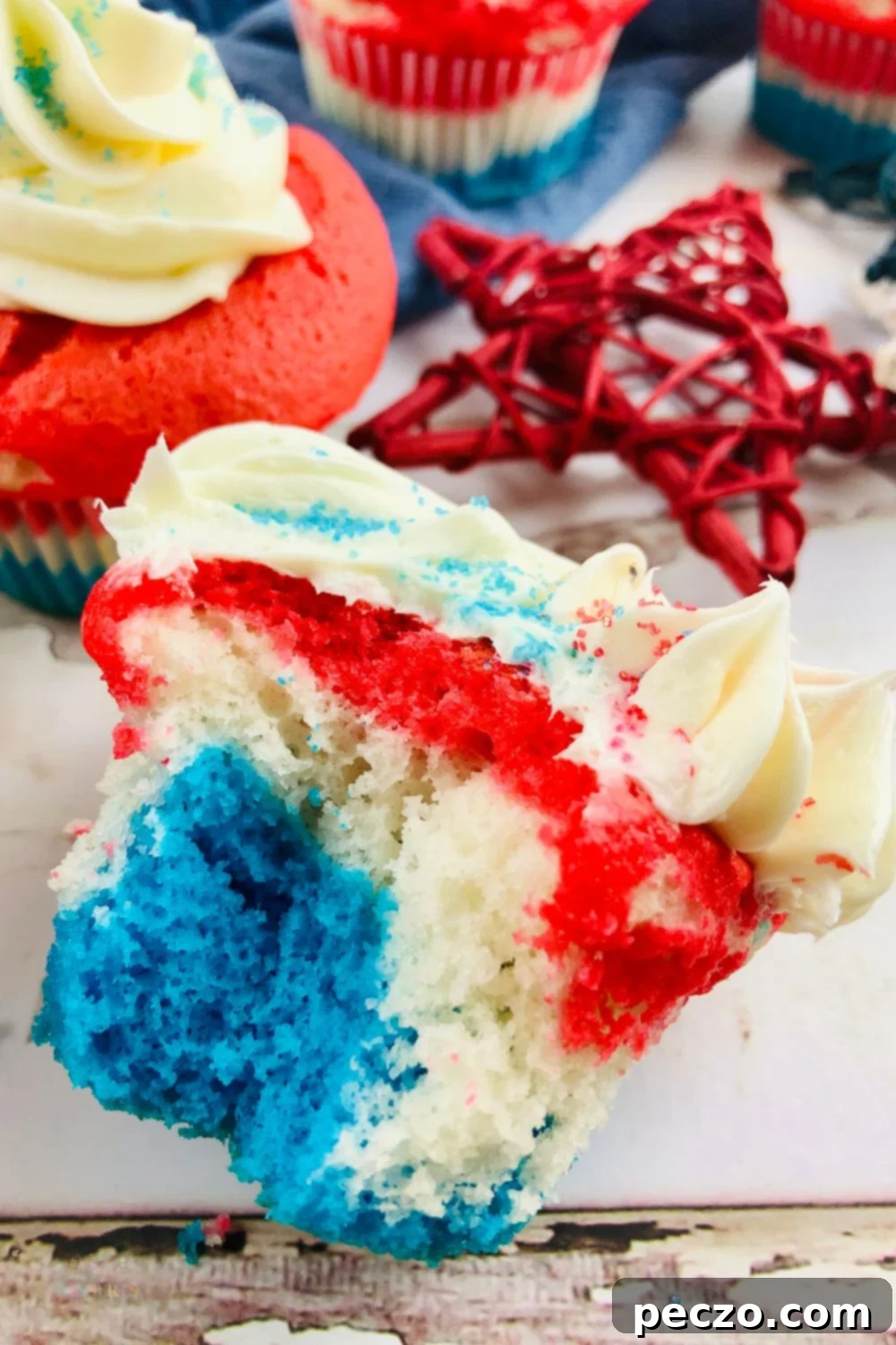 Assortment of festive Fourth of July cupcakes with various red, white, and blue toppings