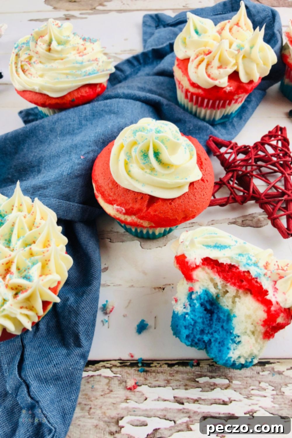 Close-up of patriotic red, white, and blue cupcakes with a generous layer of sprinkles