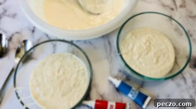 Dividing cake batter into three separate bowls for coloring