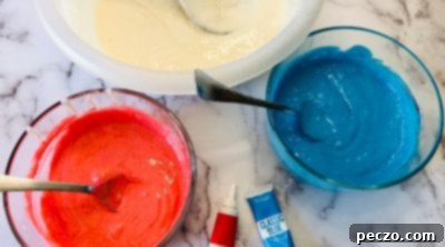 Coloring cake batter red, white, and blue in separate bowls