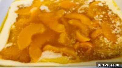 Adding peaches to cobbler