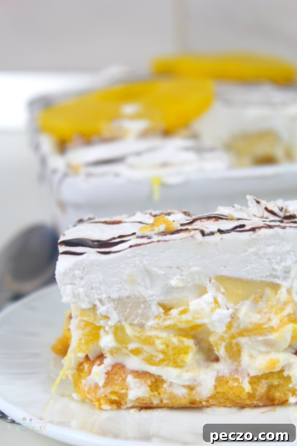 Close up image of banana split lasagna with pineapple, in a white serving plate