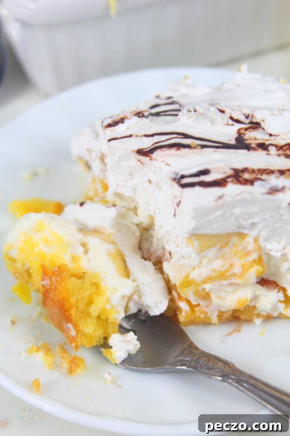 Close up image of a dessert fork filled with a piece of pineapple banana split dessert