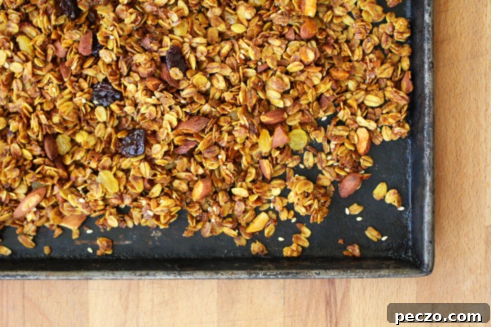 Close-up of golden turmeric granola cooling on a baking sheet