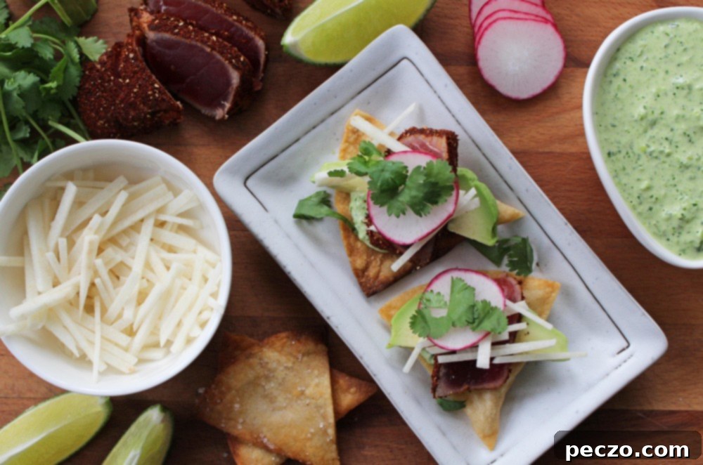 Close-up of a single beautifully layered tuna tostada with various fresh ingredients