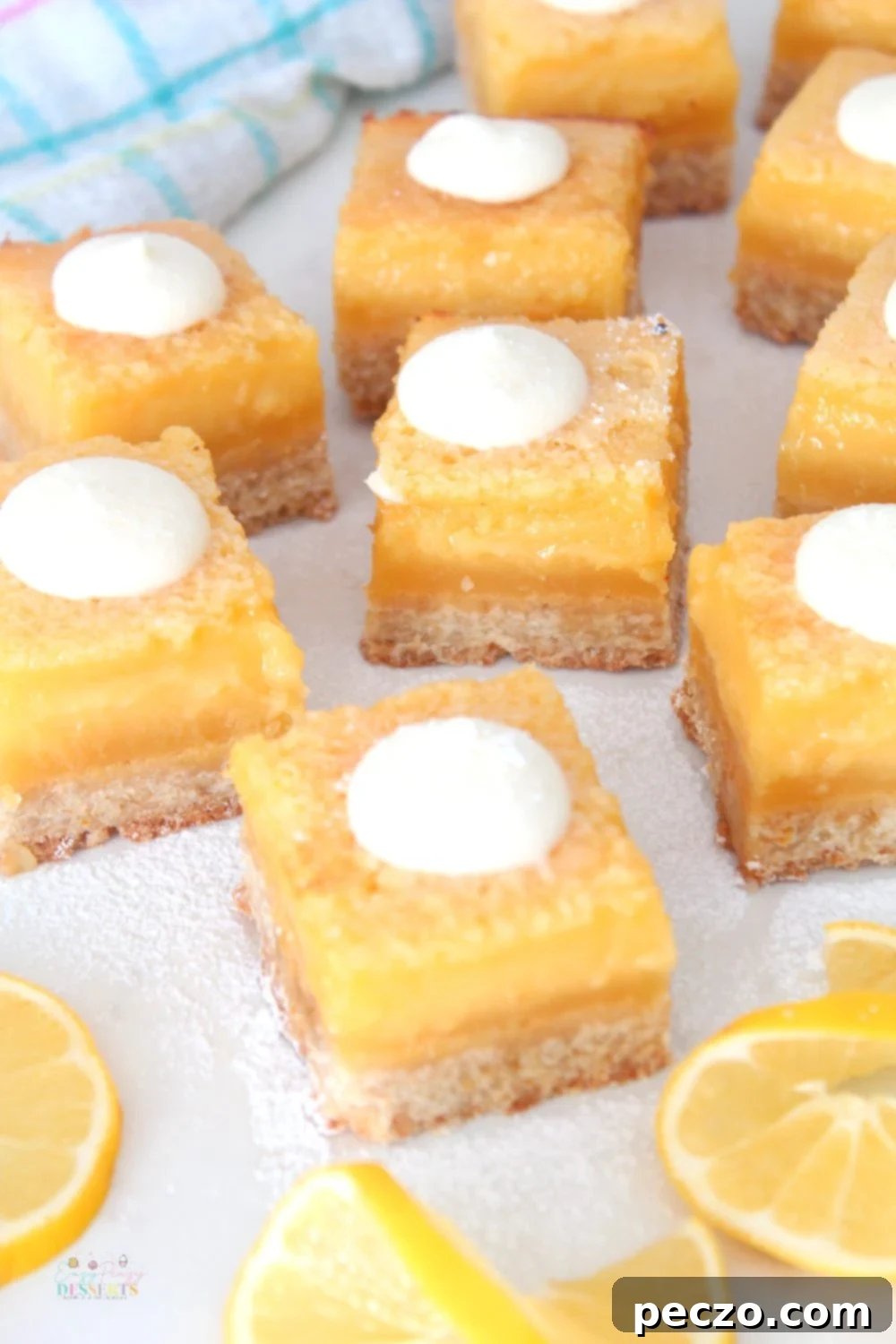many decorated lemon squares on a serving dish