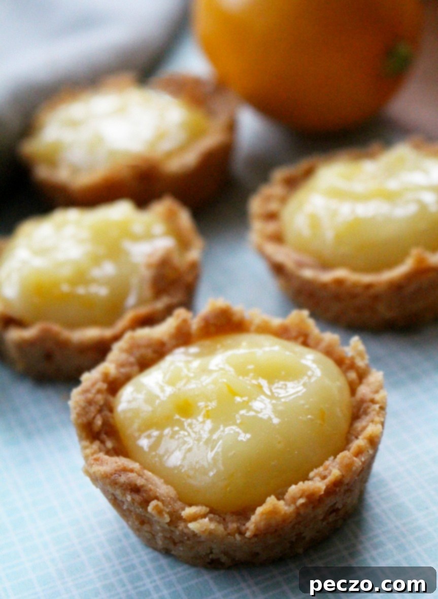 Meyer lemon tarts on a wooden surface, beautifully arranged