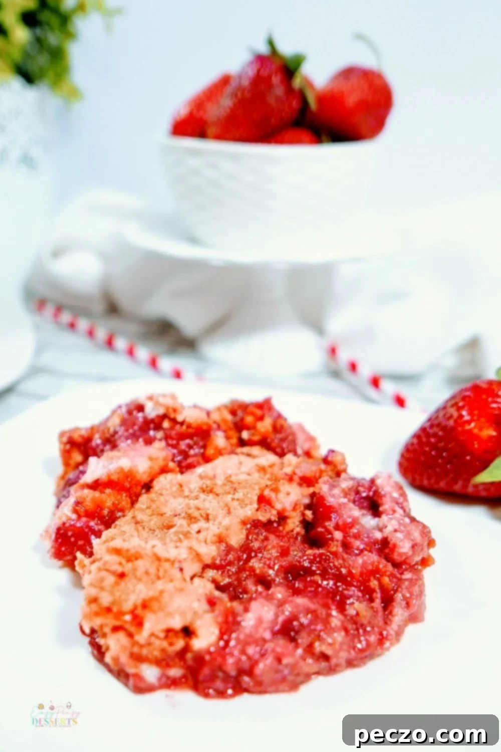 Close up image of strawberry cream cheese dump cake, showing texture