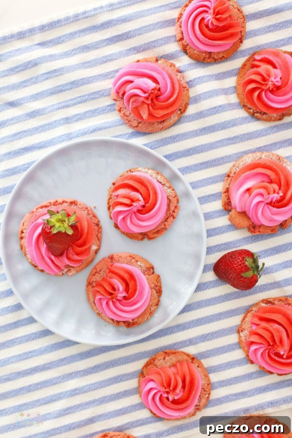 Image of delightful strawberry and cream cookies, artfully decorated with fresh strawberry slices, resting on a rustic kitchen napkin