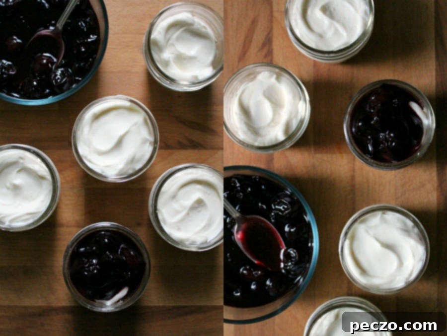 Fresh cherries on top of no-bake cheesecakes in small glass jars, ready to be served or stored.