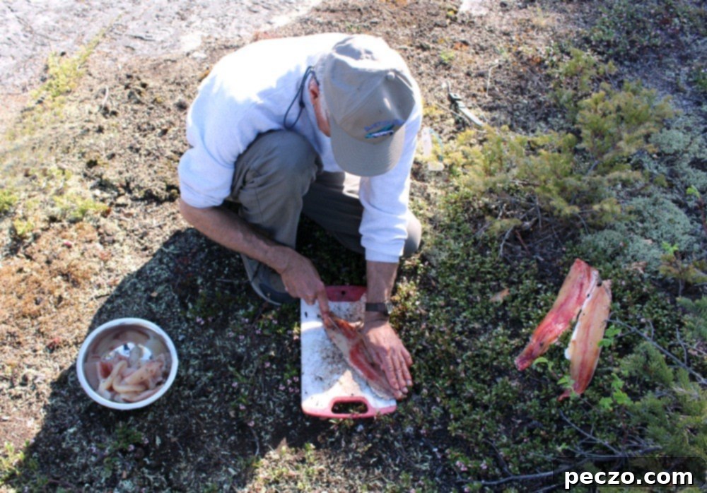 Our experienced guide cleaning freshly caught fish for an authentic shore lunch.
