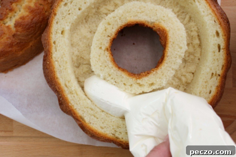 Close-up of the delicious, creamy filling being piped into the cake
