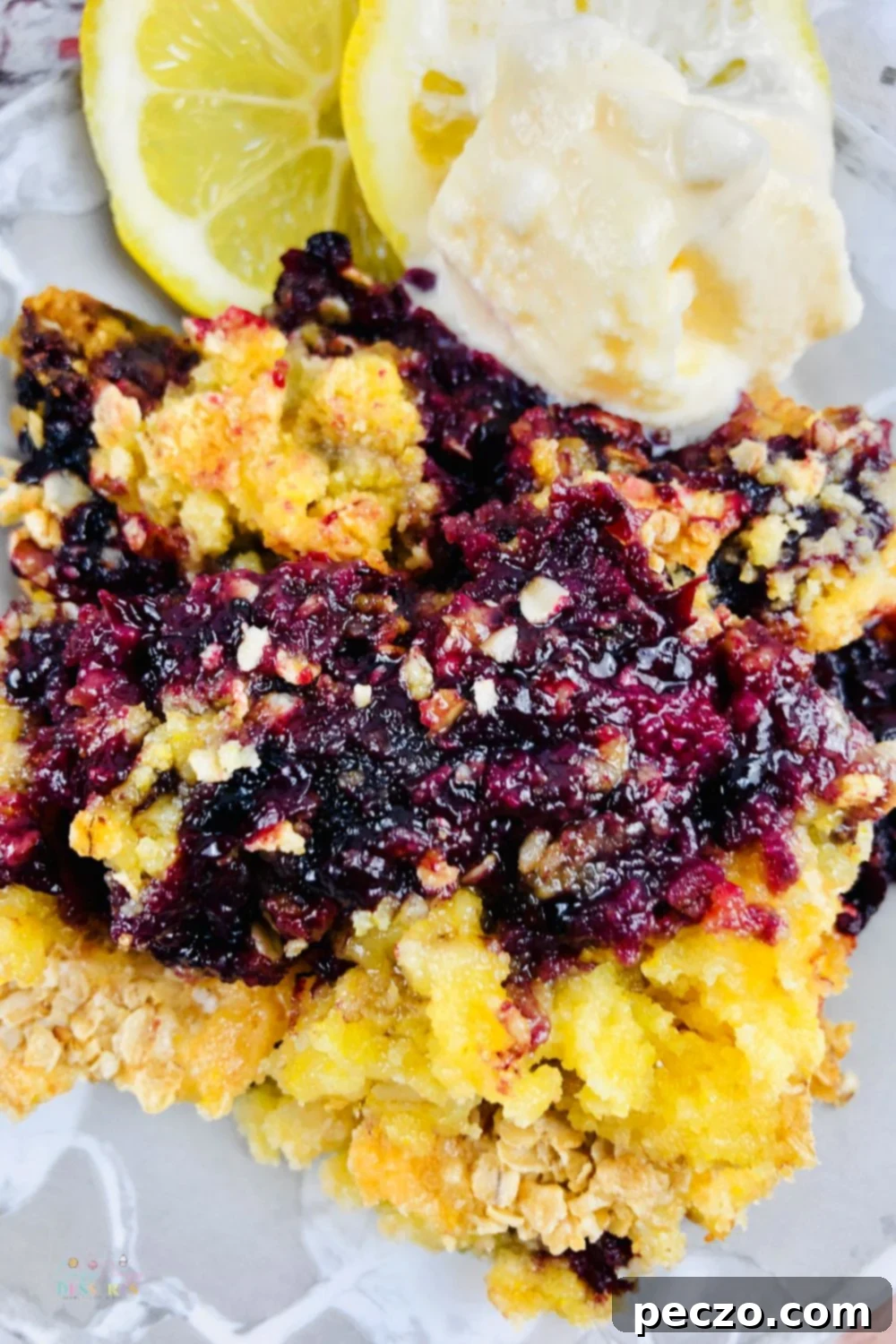 Close up image of blackberry cobber with cake mix, highlighting its texture and fruit distribution