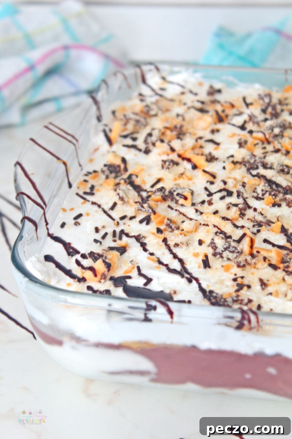 Chocolate lasagna dessert in a baking dish, perfectly layered and garnished.