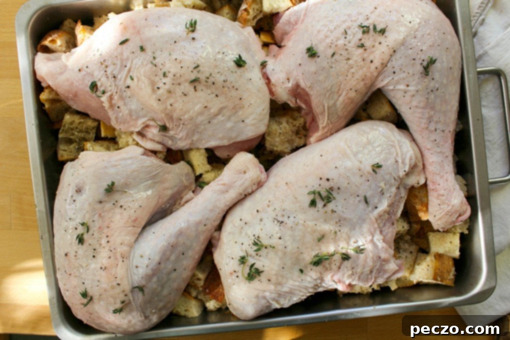 turkey pieces placed on top of stuffing in a pan