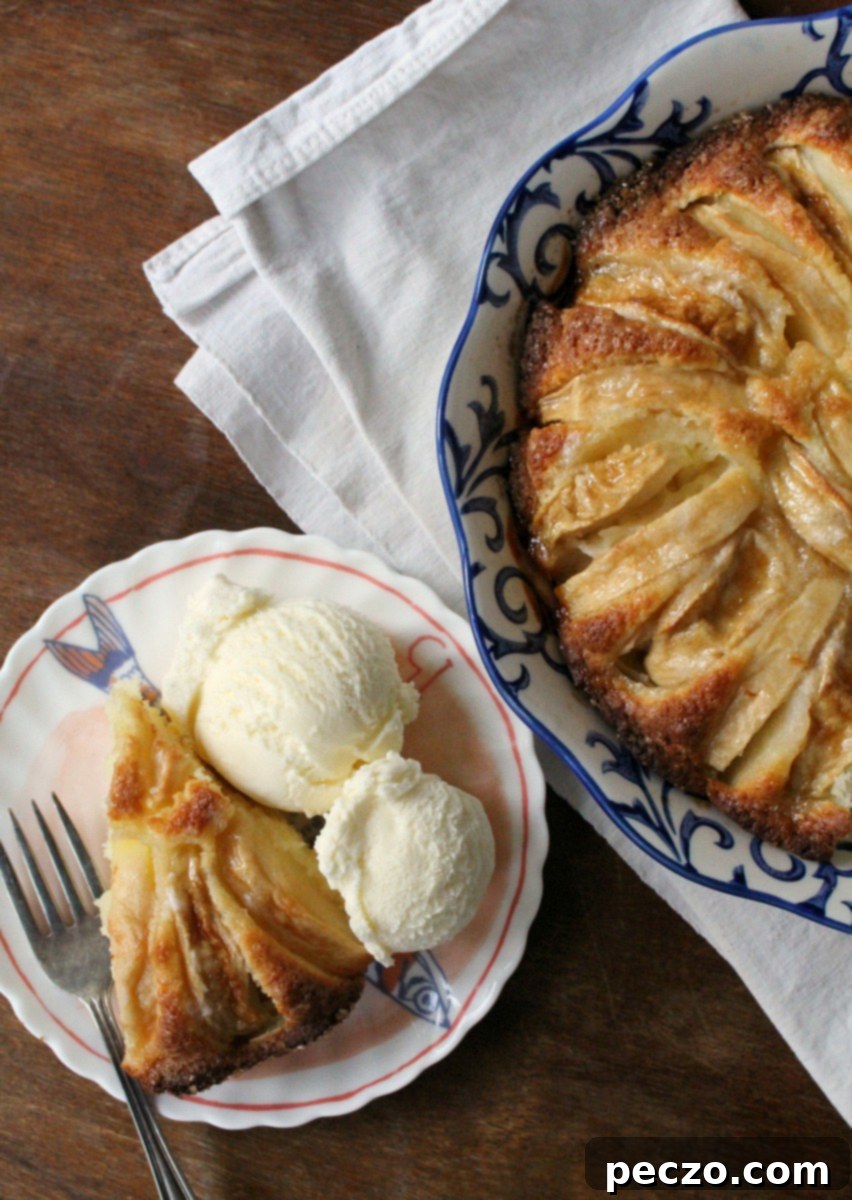 A large, round easy apple cake on a cooling rack, ready to be sliced and served