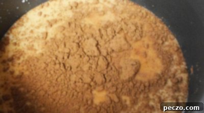 Whisking hot chocolate ingredients in a saucepan