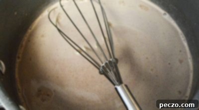 Steaming hot chocolate mixture in a saucepan