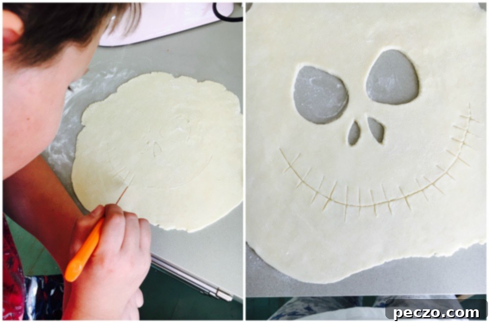 A close-up view of the Jack Skellington pie, highlighting the detailed face cut-outs revealing a rich, dark berry filling.