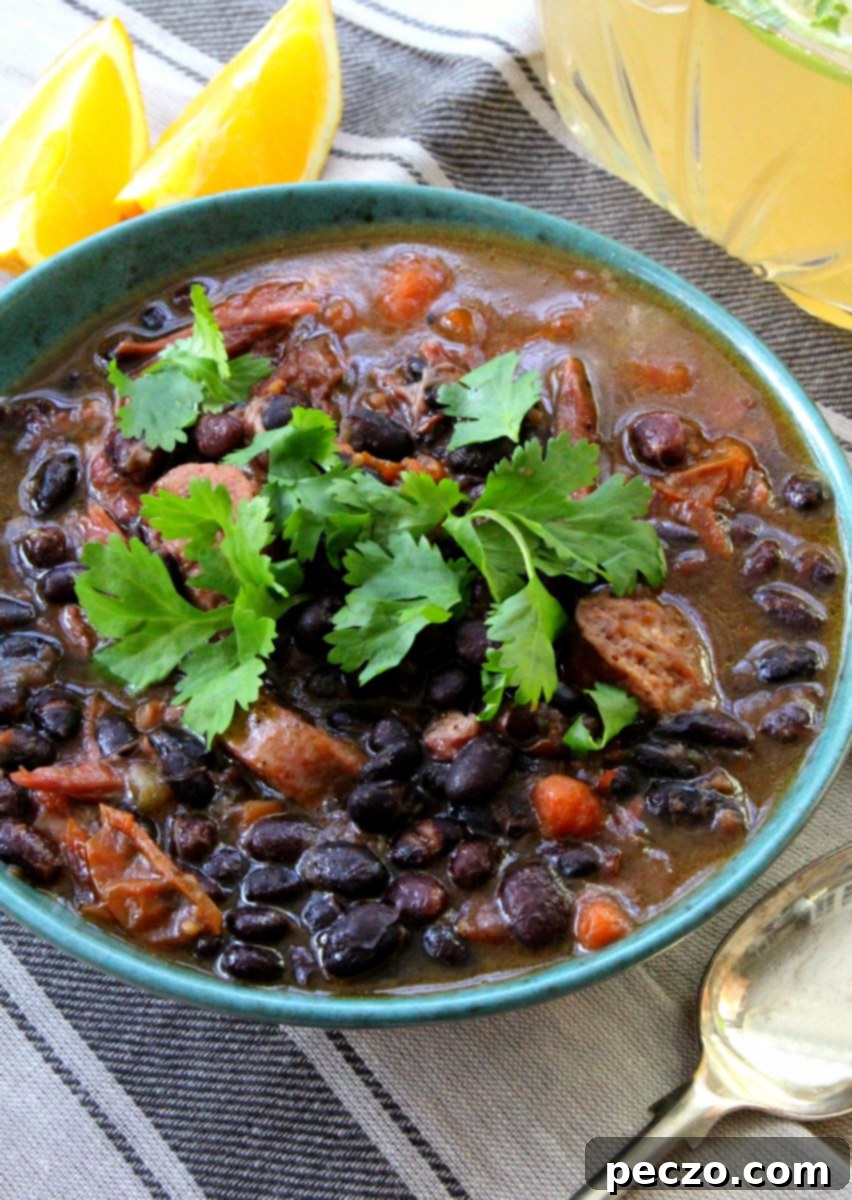 A rich, hearty pot of traditional Brazilian Feijoada simmering, filled with black beans and various cuts of pork.