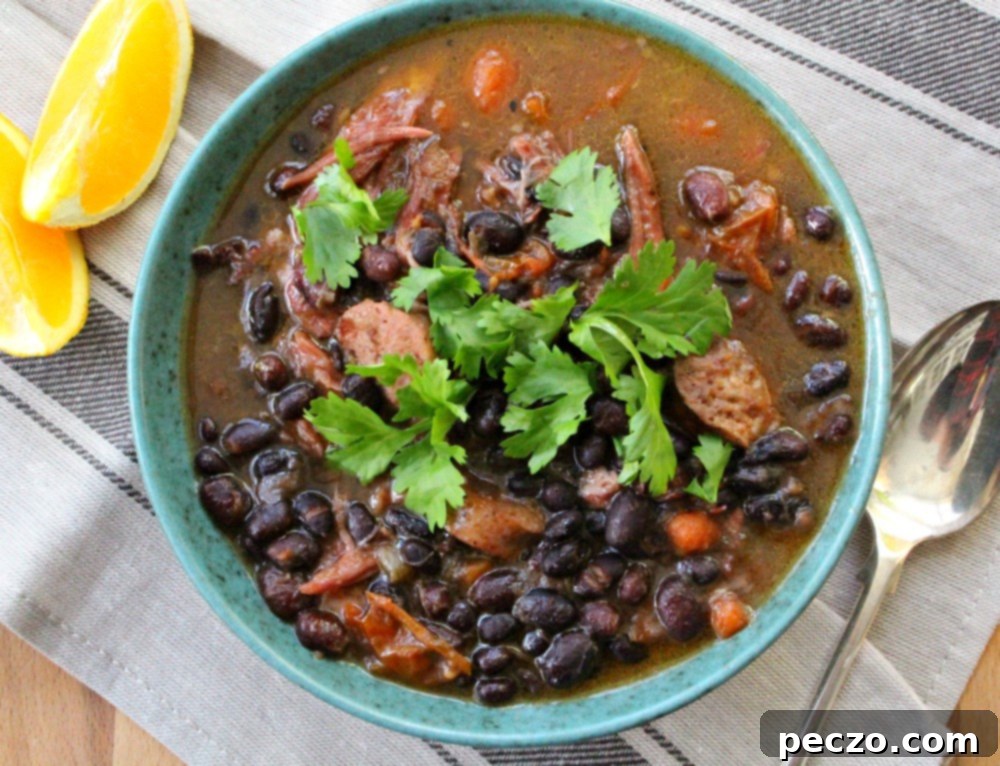 A close-up view of a serving of Feijoada, showcasing the tender meat and dark, flavorful black beans.