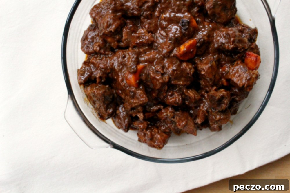 Beef stew simmering in an enamel-coated cast iron pot