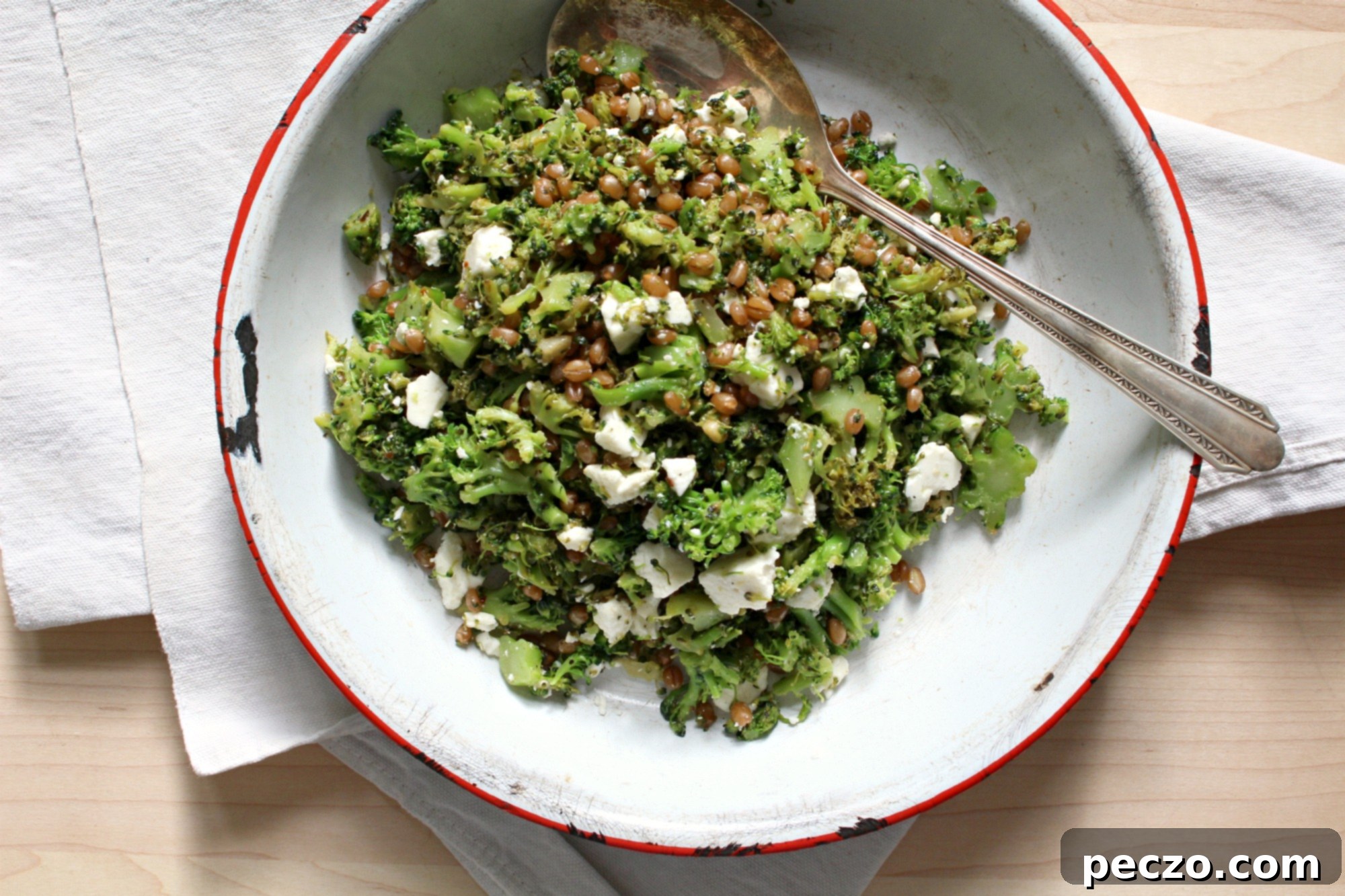 Close-up of the finished broccoli rubble dish, featuring sautéed broccoli, wheat berries, crumbled feta, and a fried egg, ready to be enjoyed.