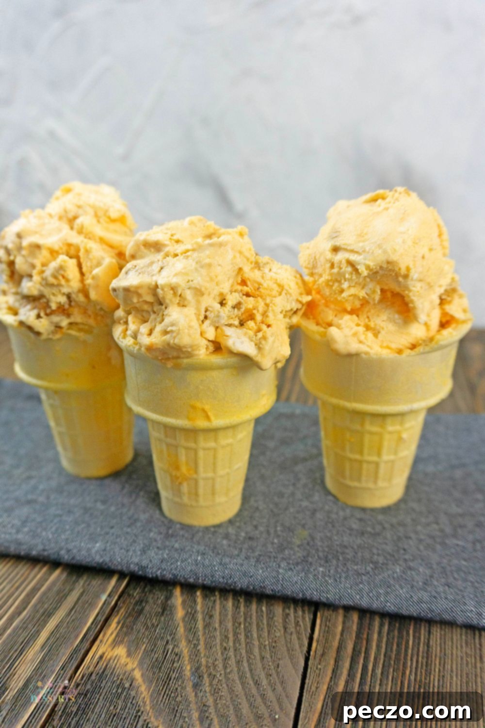 Close up image of pumpkin gingersnap ice cream in ice cream cones