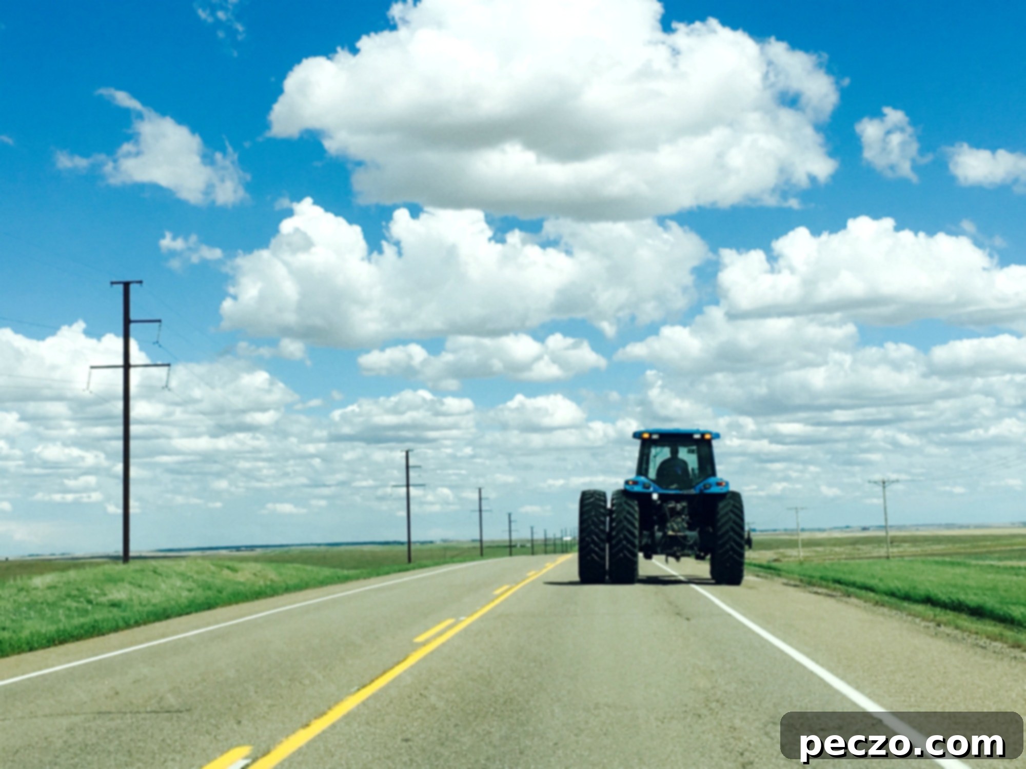 Saskatchewan Tractor - A large tractor in a field under a vast sky