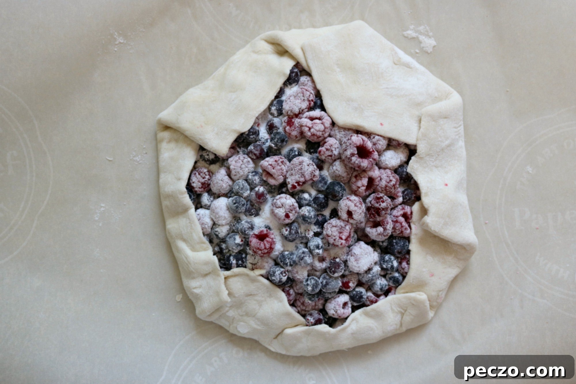 Mixing raspberry and saskatoon berries for galette filling
