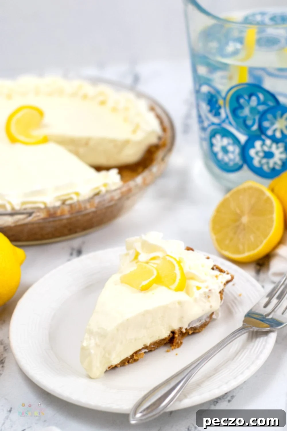 Close up image of a slice of sugar free lemon pie decorated with a slice of lemon