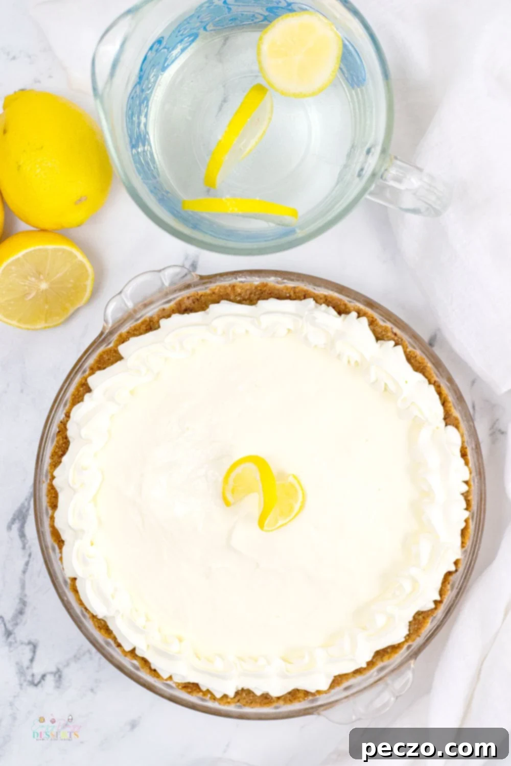 Overhead image of a whole lemon cream cheese pie in a pie dish