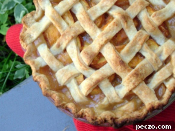 Delicious homemade peach pie fresh from the oven, with a golden, flaky crust