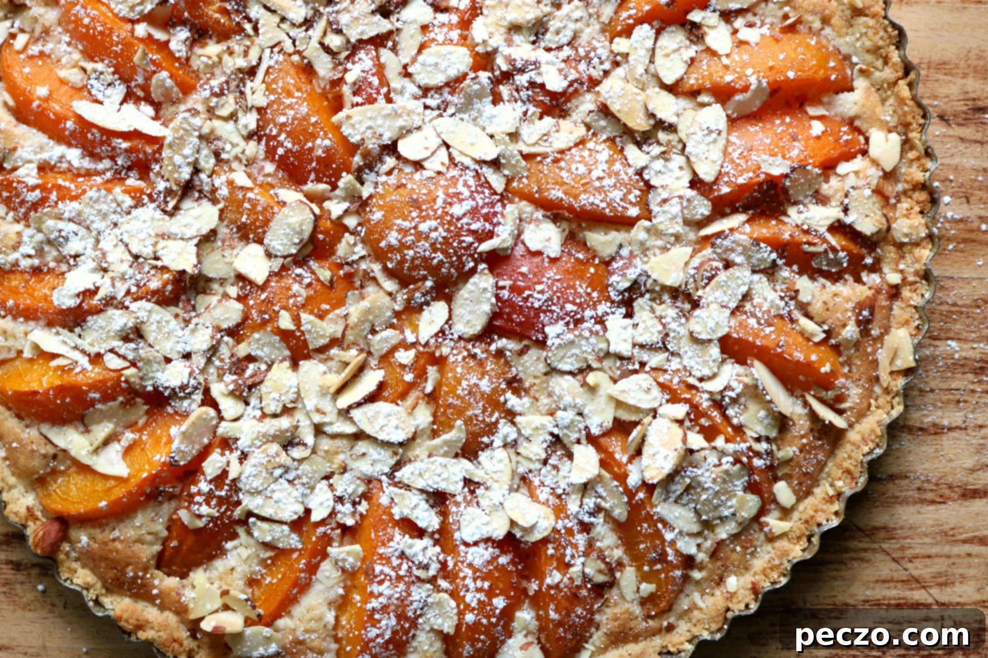 Top-down view of the baked apricot frangipane tart, golden and inviting