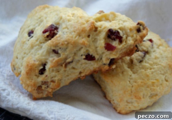 Freshly baked lemon walnut scones cooling on a wire rack, ready to be enjoyed with a block of butter