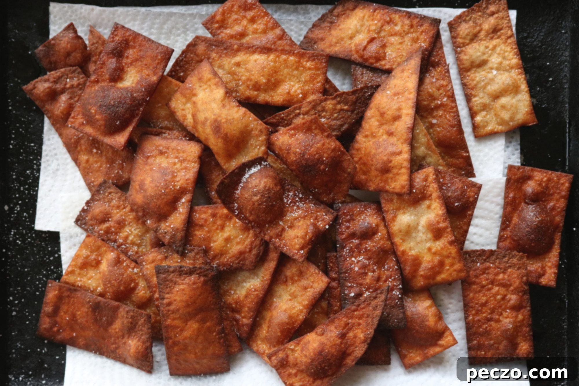 Close-up of freshly fried papdi crackers, showing their crispy texture and golden color.