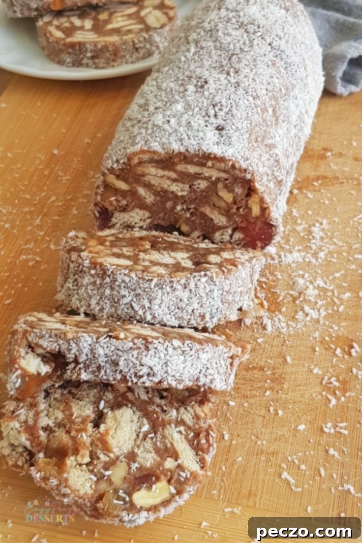 Classic no-bake chocolate salami log on a wooden board with cocoa powder