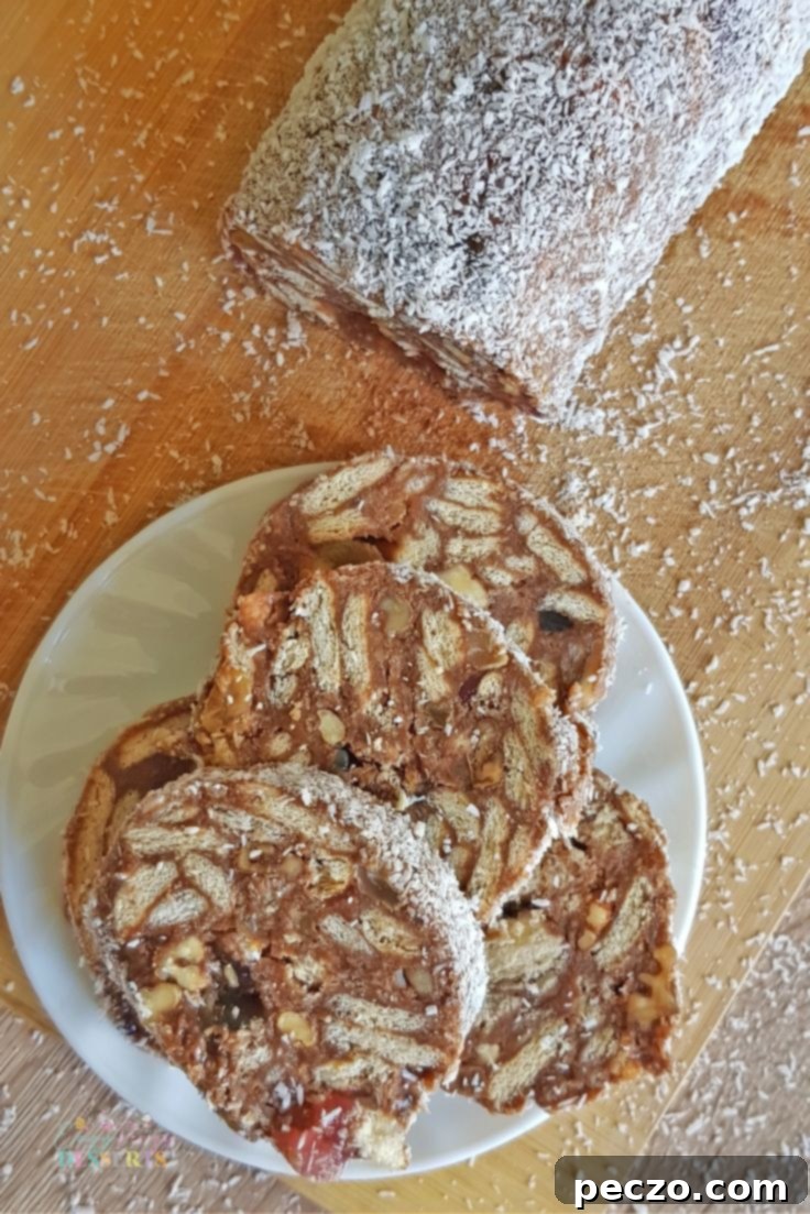 Close up of chocolate salami slices dusted with powdered sugar and coconut