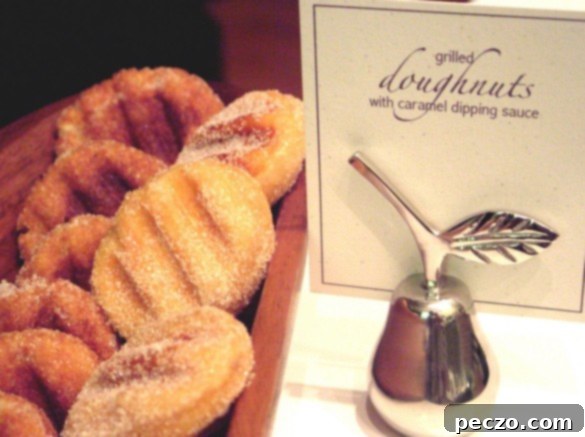 Freshly grilled mini donuts, golden brown and perfectly marked, arranged for a party